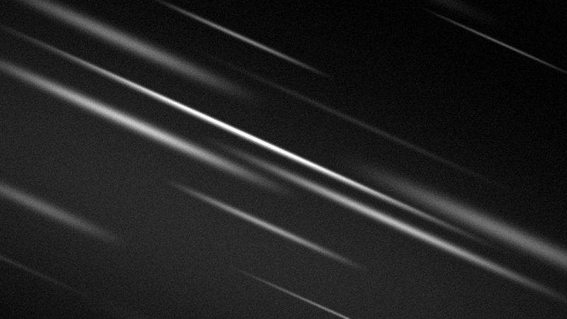 Feixes de luz em diagonal sobre fundo preto
